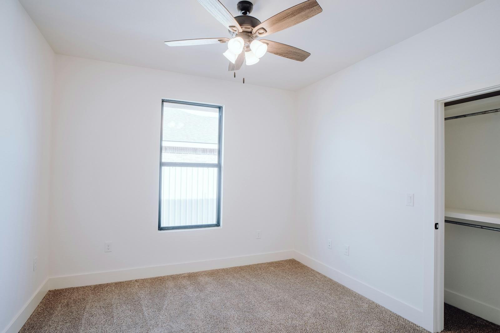 Empty bedroom with white walls and carpet